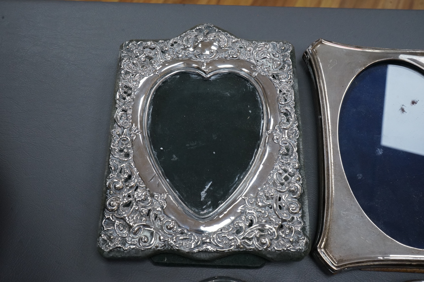 Four assorted early 20th century silver mounted photograph frames, the largest with pierced decoration, Chester, 1902, 19.5cm.